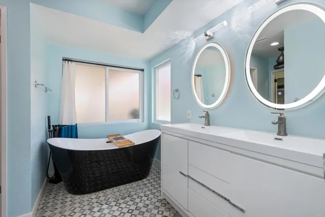 a bath room with a mirror and a sink
