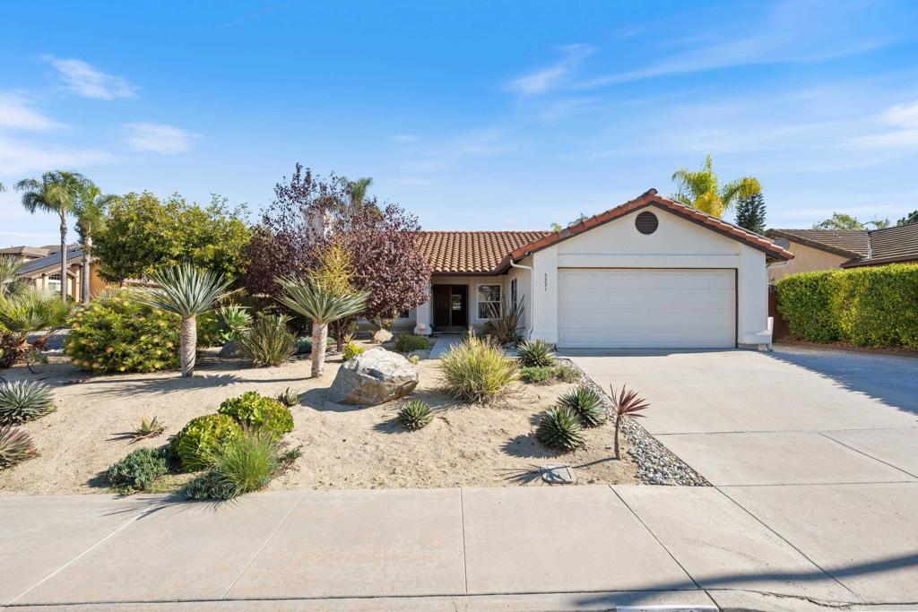 5331 Mead Street Oceanside, CA 92056 - Photo 2 of 29 a front view of a house with a yard and garage