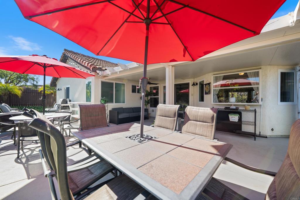 5331 Mead Street Oceanside, CA 92056 - Photo 24 of 29 a view of a patio with a table and chairs under an umbrella
