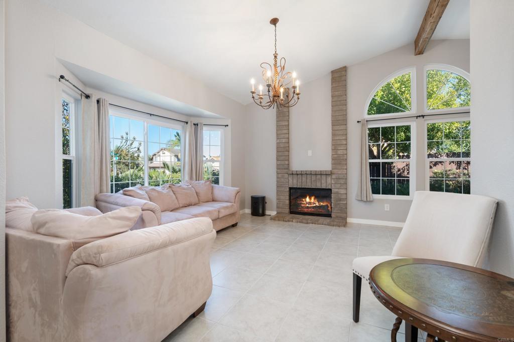 5331 Mead Street Oceanside, CA 92056 - Photo 3 of 29 a living room with furniture a fireplace and a chandelier