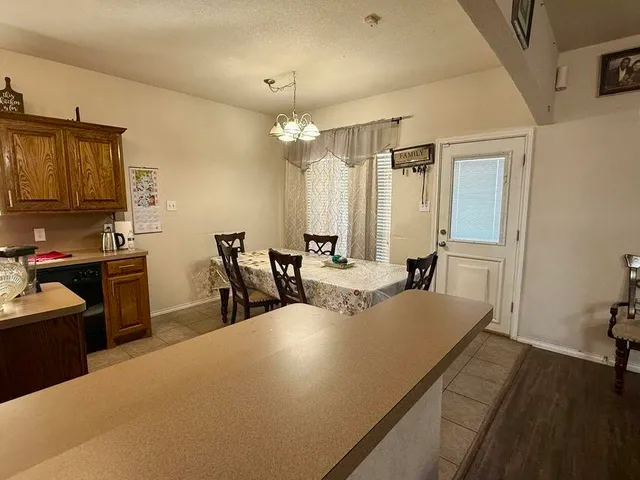 a large white kitchen with a large window