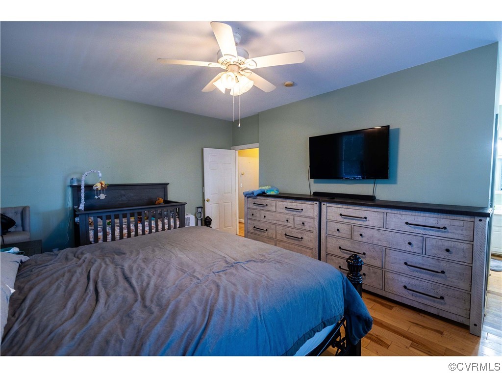1047 Camera Road Waverly, VA 23890 - Photo 11 of 48 a bedroom with a bed and a flat screen tv