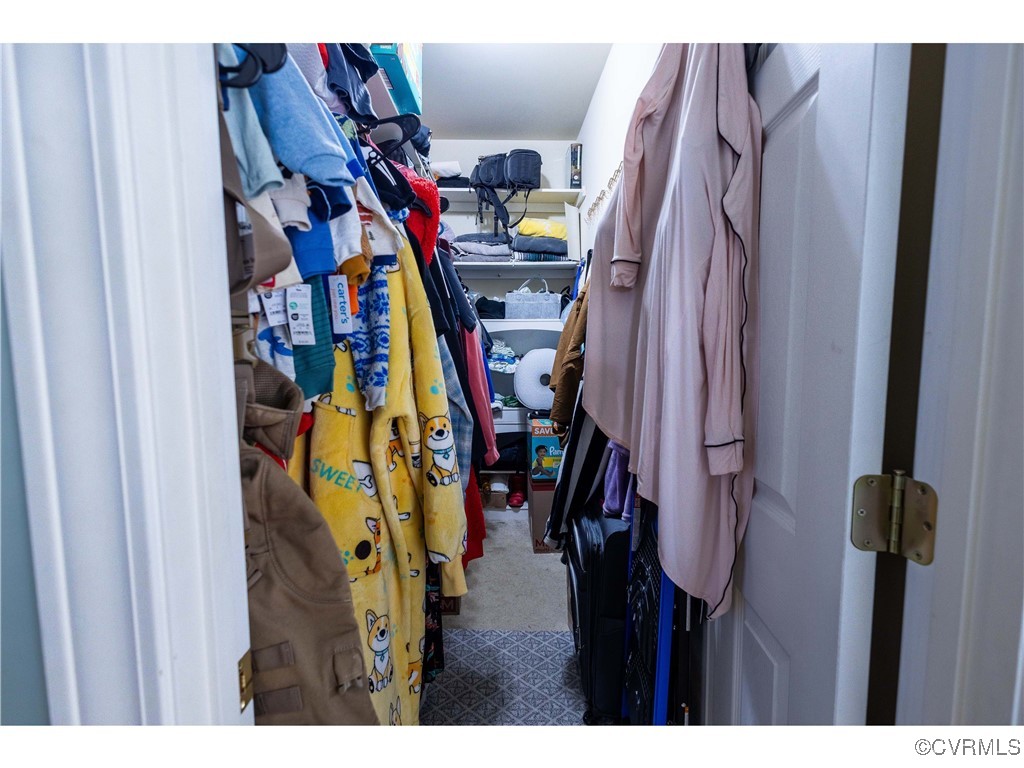1047 Camera Road Waverly, VA 23890 - Photo 13 of 48 a view of walk in closet with clothes