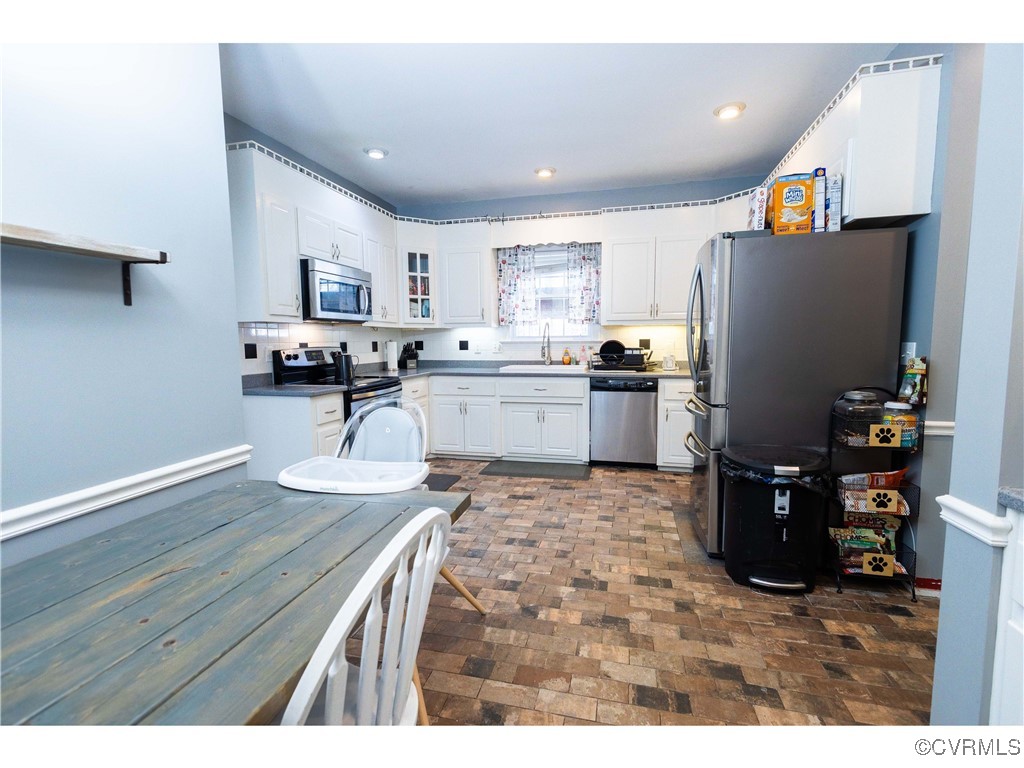 1047 Camera Road Waverly, VA 23890 - Photo 27 of 48 a kitchen with a refrigerator and a stove top oven