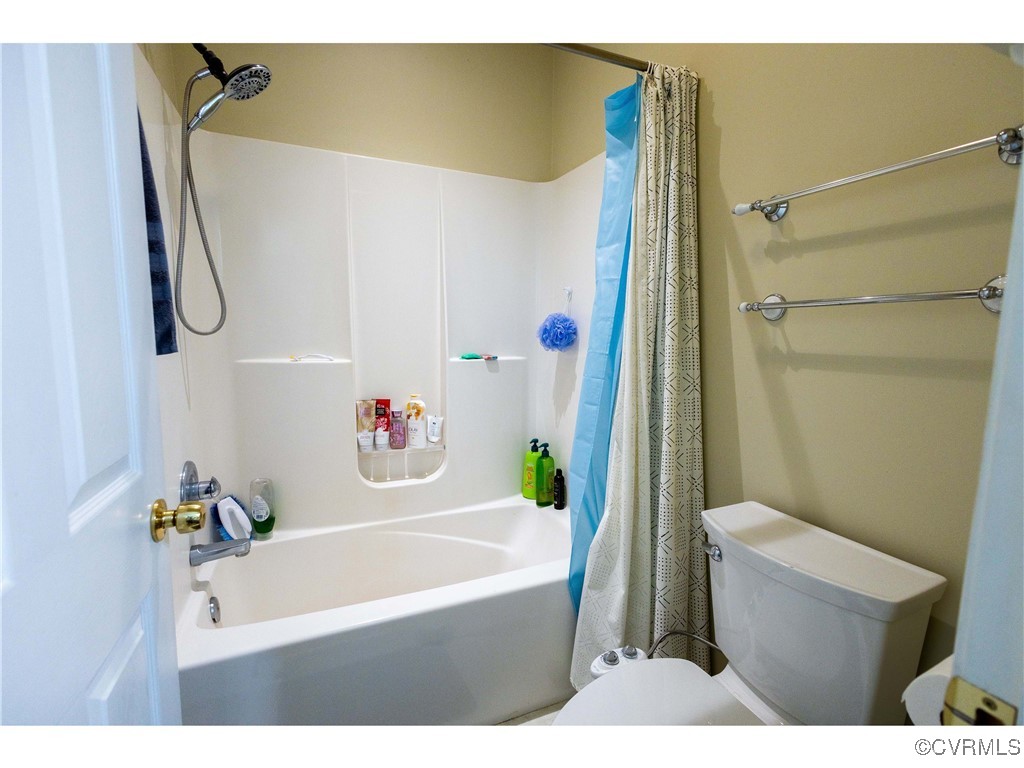 1047 Camera Road Waverly, VA 23890 - Photo 29 of 48 a bathroom with a bathtub a sink and a shower