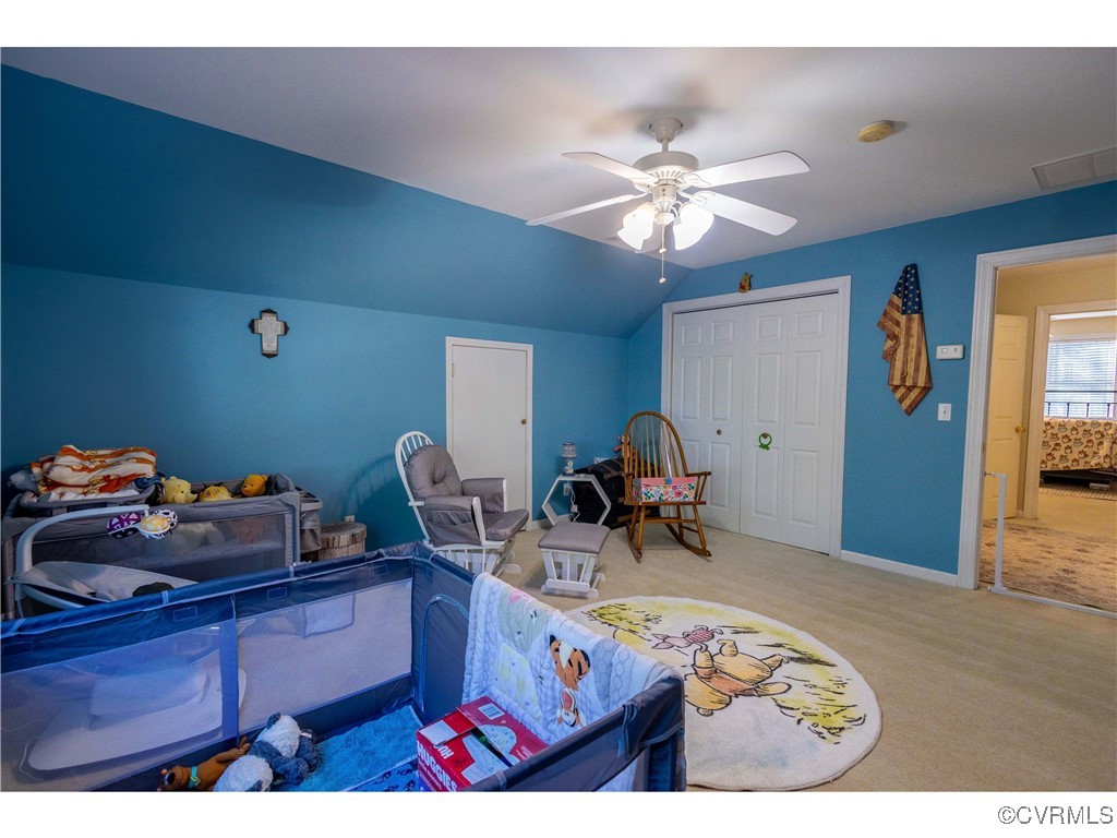 1047 Camera Road Waverly, VA 23890 - Photo 33 of 48 a bed room with a bed and a chandelier
