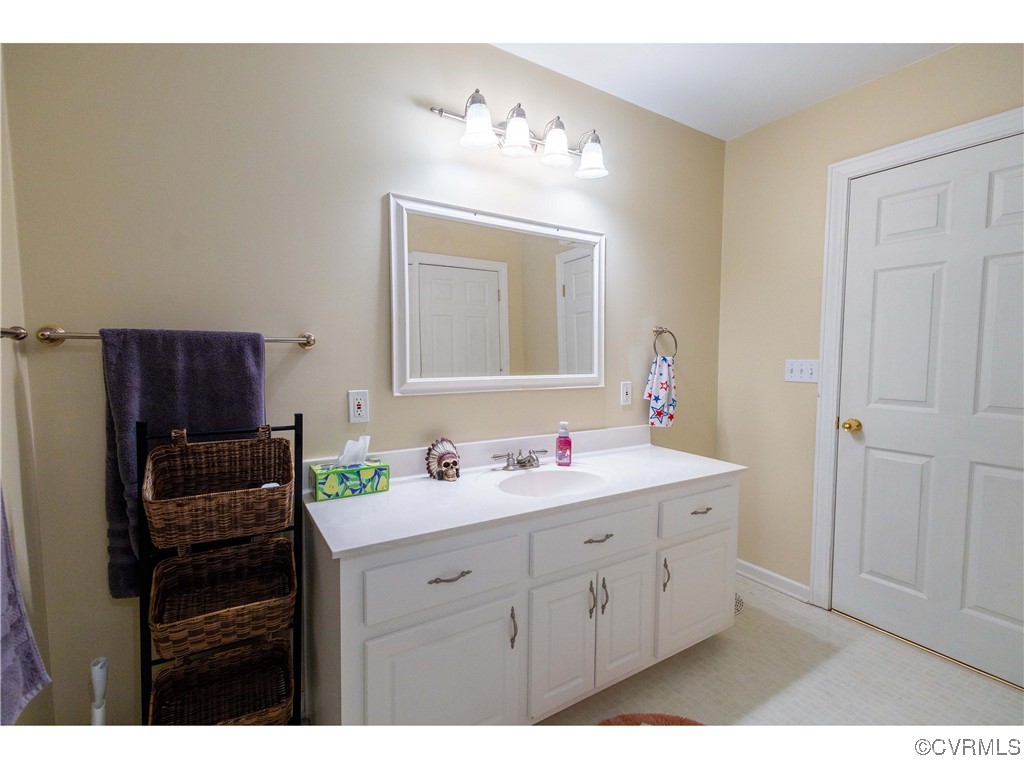 1047 Camera Road Waverly, VA 23890 - Photo 37 of 48 a bathroom with a double vanity sink mirror and