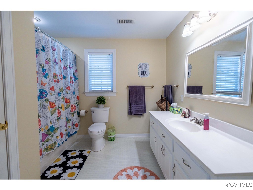 1047 Camera Road Waverly, VA 23890 - Photo 38 of 48 a bathroom with a sink mirror vanity and toilet
