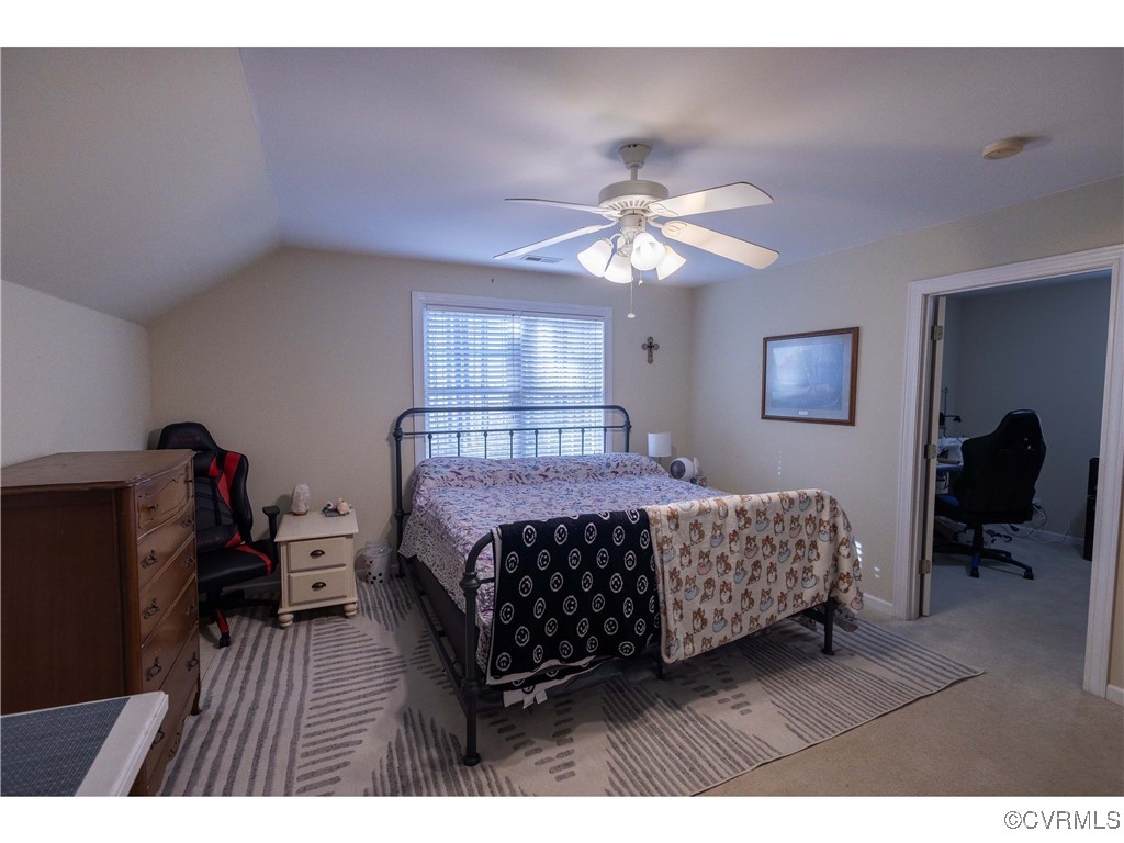 1047 Camera Road Waverly, VA 23890 - Photo 40 of 48 a bedroom with a bed chandelier and a window