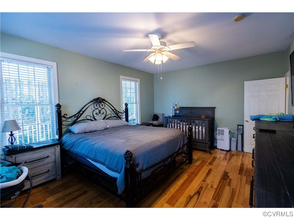 1047 Camera Road Waverly, VA 23890 - Photo 10 of 48 a bedroom with a bed and a chandelier