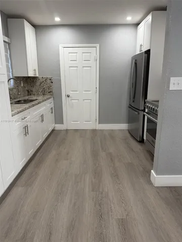 a kitchen with stainless steel appliances a refrigerator stove and sink