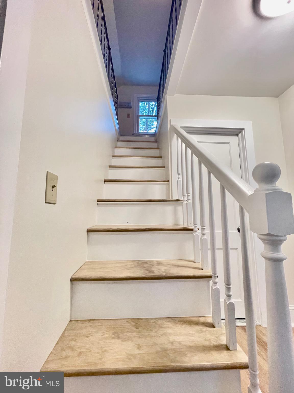 26540 Deal Island Road Princess Anne, MD 21853 - Photo 44 of 76 a view of staircase with white walls and a rug