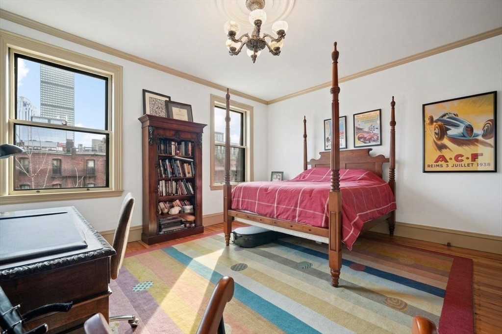 381 Beacon Street Boston, MA 02116 - Photo 16 of 21 a bedroom with a bed and wooden floor