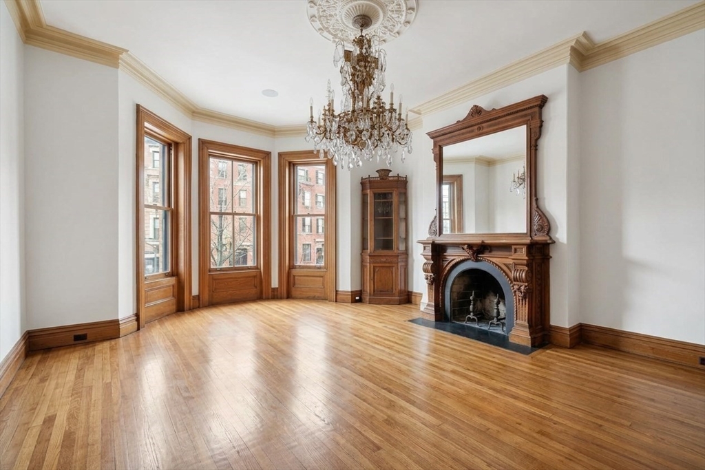 381 Beacon Street Boston, MA 02116 - Photo 6 of 21 a view of livingroom with washer and dryer wooden floor