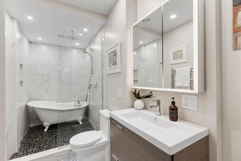 261 Marlborough Street, Unit 4R Boston, MA 02116 - Photo 27 of 36 a bathroom with a sink toilet vanity and shower