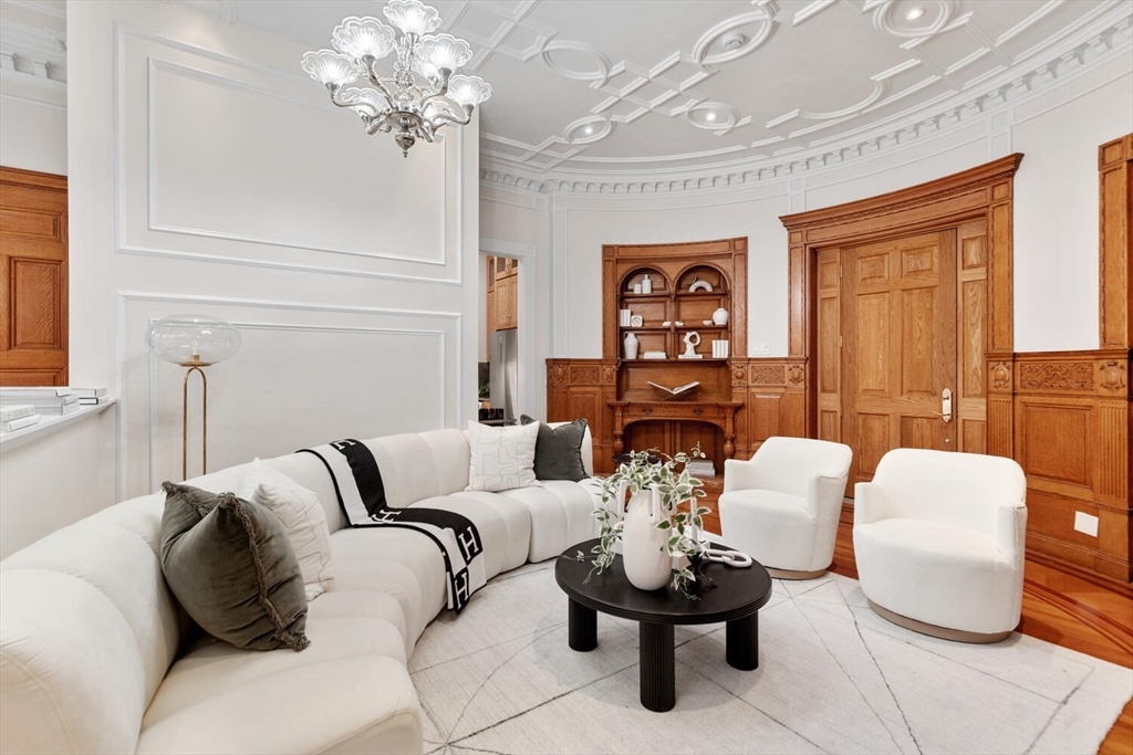 261 Marlborough Street, Unit 4R Boston, MA 02116 - Photo 6 of 36 a living room with furniture and a chandelier