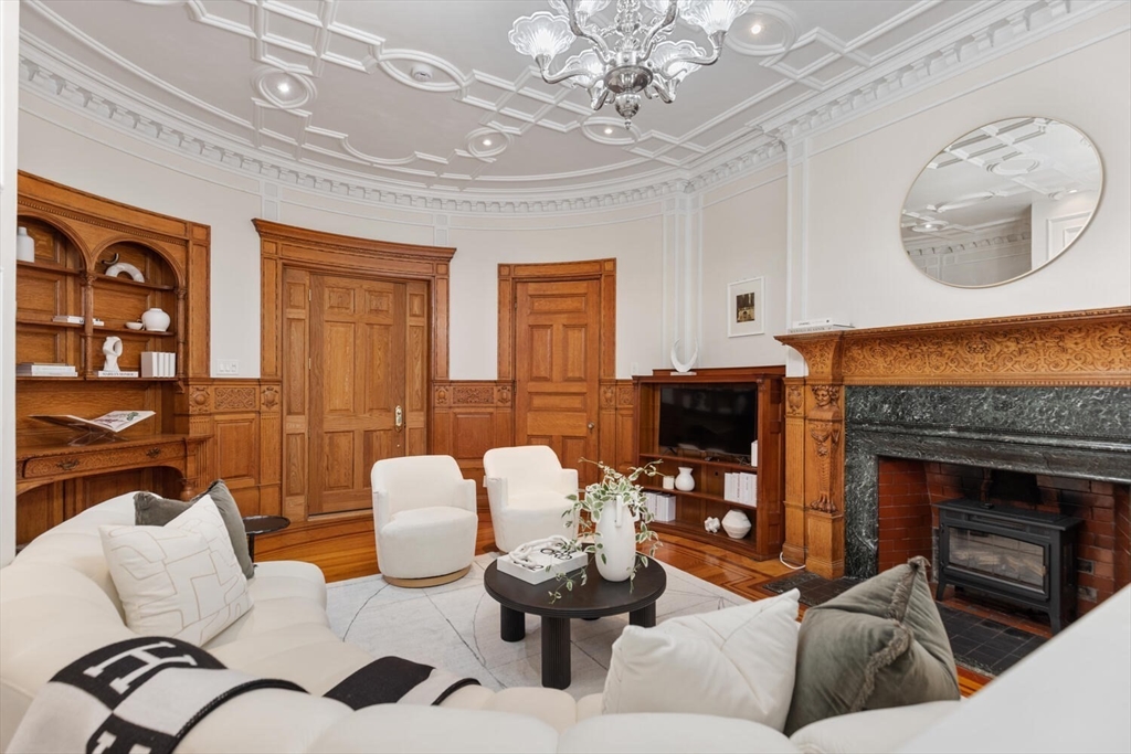 261 Marlborough Street, Unit 4R Boston, MA 02116 - Photo 7 of 36 a living room with furniture and a fireplace