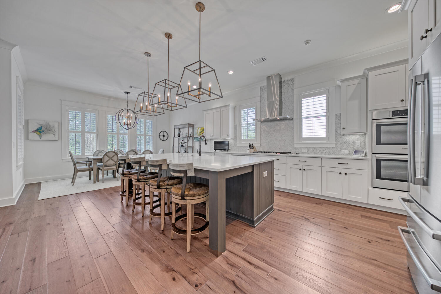 235 Ridgewalk Circle Santa Rosa Beach, FL 32459 - Photo 2 of 44 a kitchen with stainless steel appliances a dining table chairs stove and cabinets