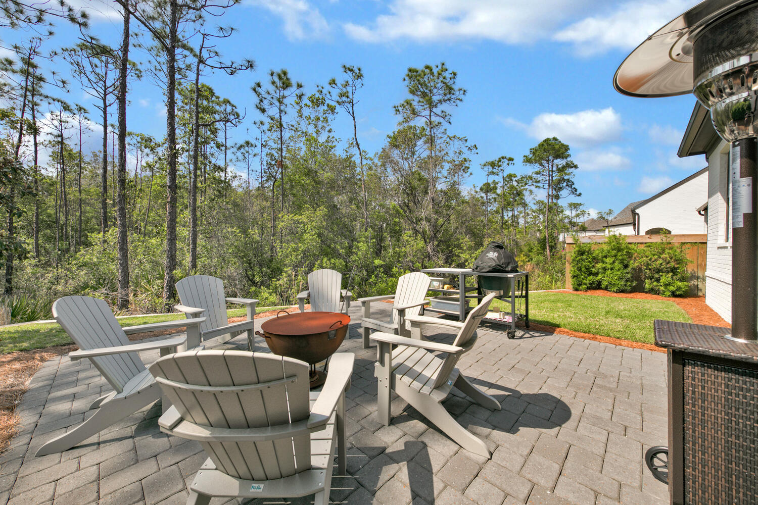 235 Ridgewalk Circle Santa Rosa Beach, FL 32459 - Photo 25 of 44 a view of a patio with couches chairs and a potted plant