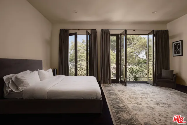 a bedroom with a large bed and a large window