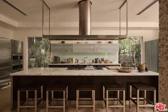 a kitchen with stainless steel appliances granite countertop a sink and a stove