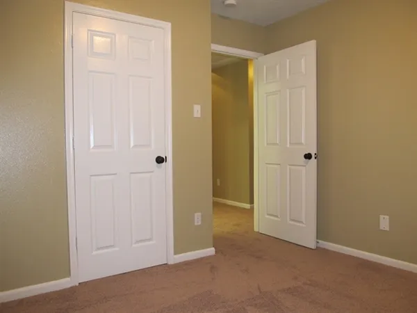an empty room with closet area