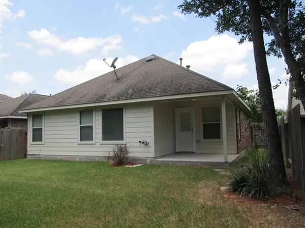 a front view of a house with a garden and yard