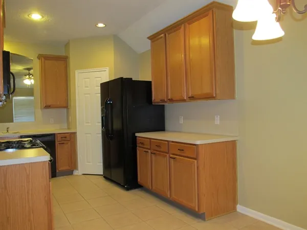 a kitchen with a refrigerator a stove top oven and a dishwasher