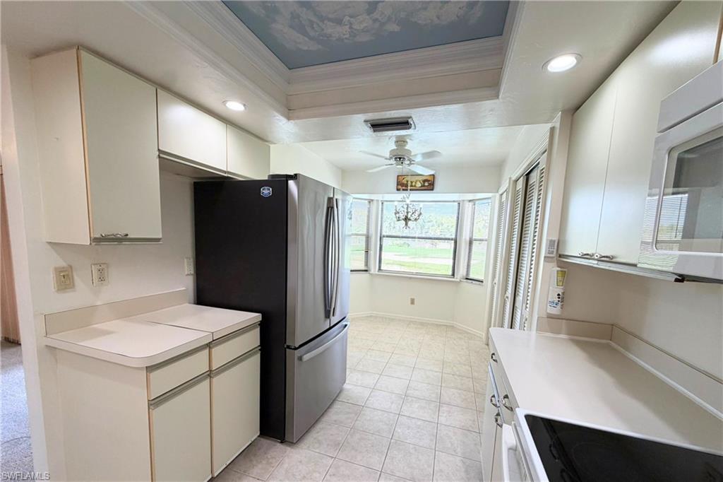 7360 St Ives Way, Unit 2205 Naples, FL 34104 - Photo 13 of 37 a kitchen with stainless steel appliances a refrigerator and a stove