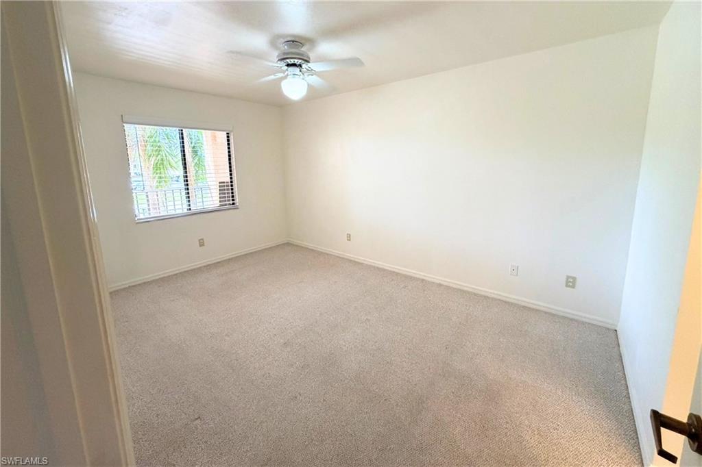 7360 St Ives Way, Unit 2205 Naples, FL 34104 - Photo 19 of 37 an empty room with a window
