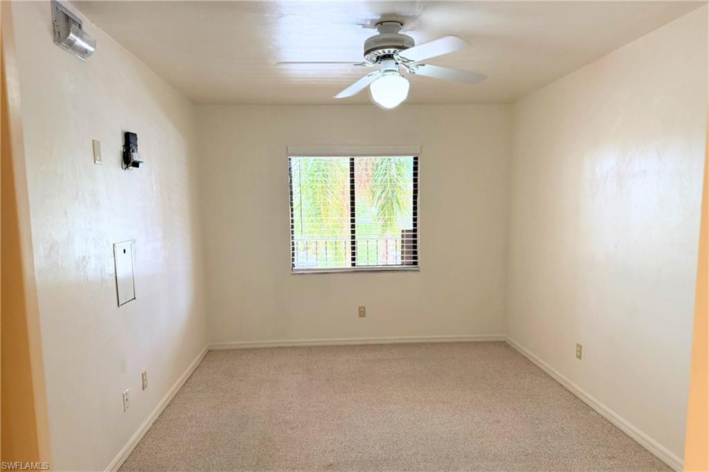 7360 St Ives Way, Unit 2205 Naples, FL 34104 - Photo 20 of 37 an empty room with a window and a fan