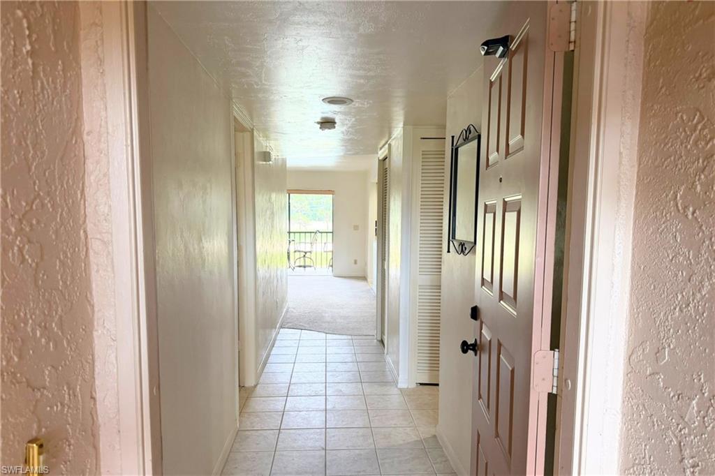 7360 St Ives Way, Unit 2205 Naples, FL 34104 - Photo 2 of 37 a view of a bathroom from the hallway