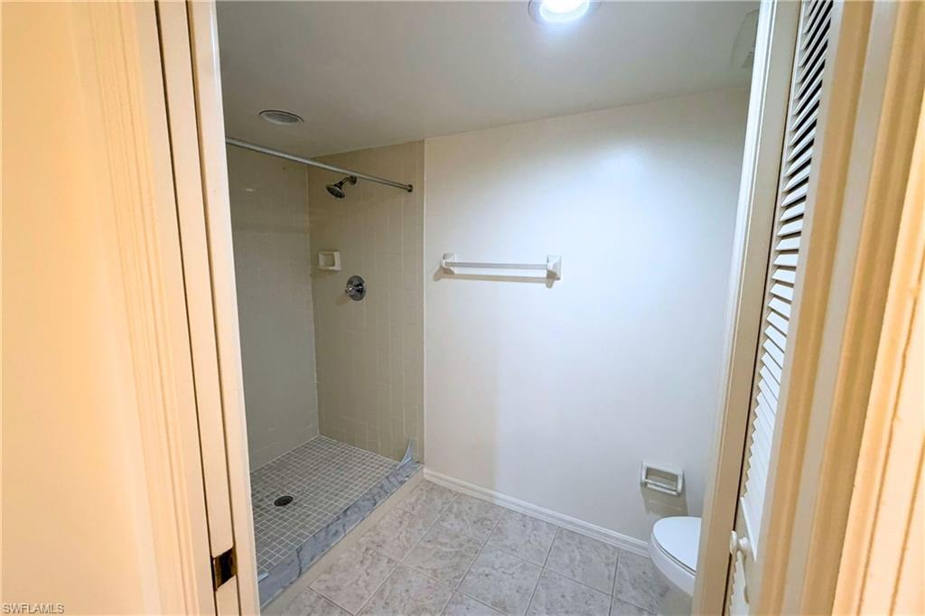 7360 St Ives Way, Unit 2205 Naples, FL 34104 - Photo 25 of 37 a bathroom with a sink and a shower