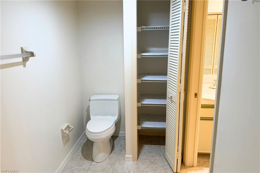 7360 St Ives Way, Unit 2205 Naples, FL 34104 - Photo 26 of 37 a bathroom with a toilet and a sink