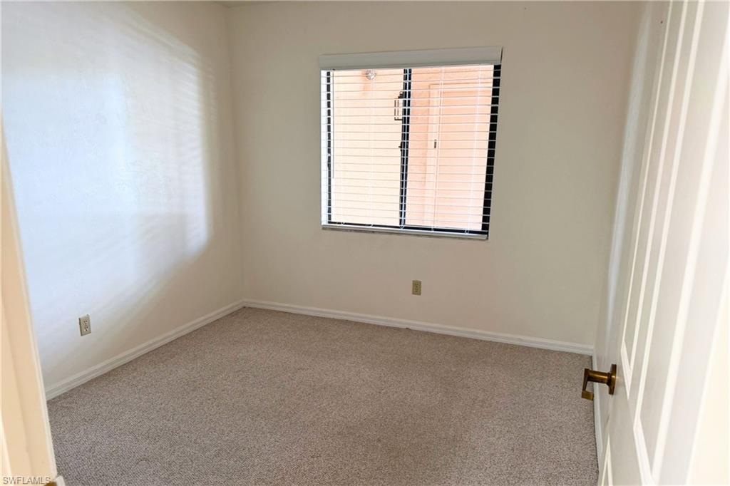 7360 St Ives Way, Unit 2205 Naples, FL 34104 - Photo 29 of 37 an empty room with a window
