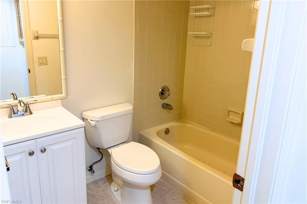 7360 St Ives Way, Unit 2205 Naples, FL 34104 - Photo 31 of 37 a bathroom with a sink toilet and shower