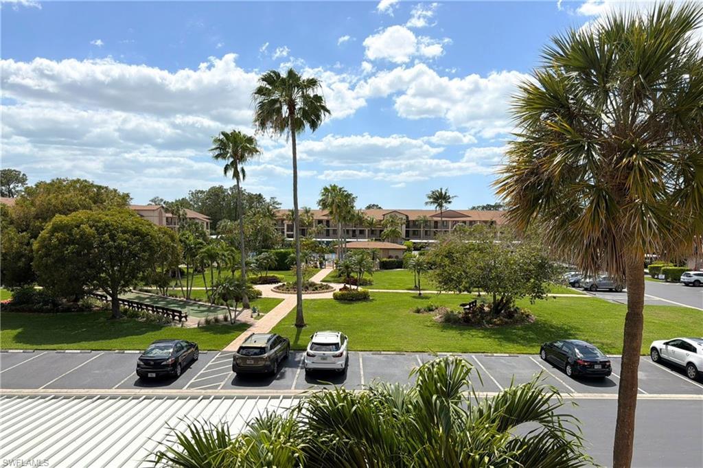 7360 St Ives Way, Unit 2205 Naples, FL 34104 - Photo 34 of 37 a view of a garden with sitting area