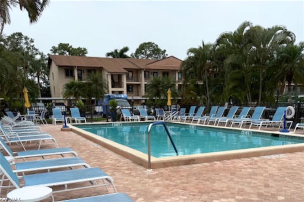 7360 St Ives Way, Unit 2205 Naples, FL 34104 - Photo 37 of 37 a view of a house with swimming pool and sitting area