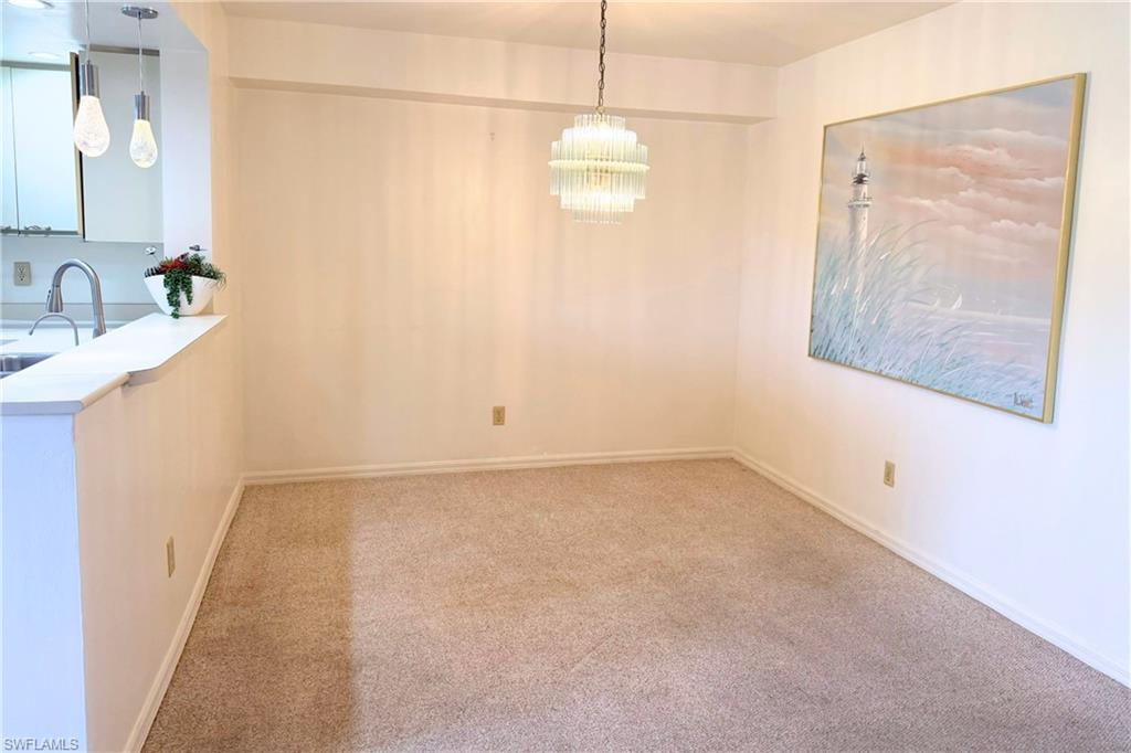 7360 St Ives Way, Unit 2205 Naples, FL 34104 - Photo 4 of 37 a bathroom with a sink and a mirror