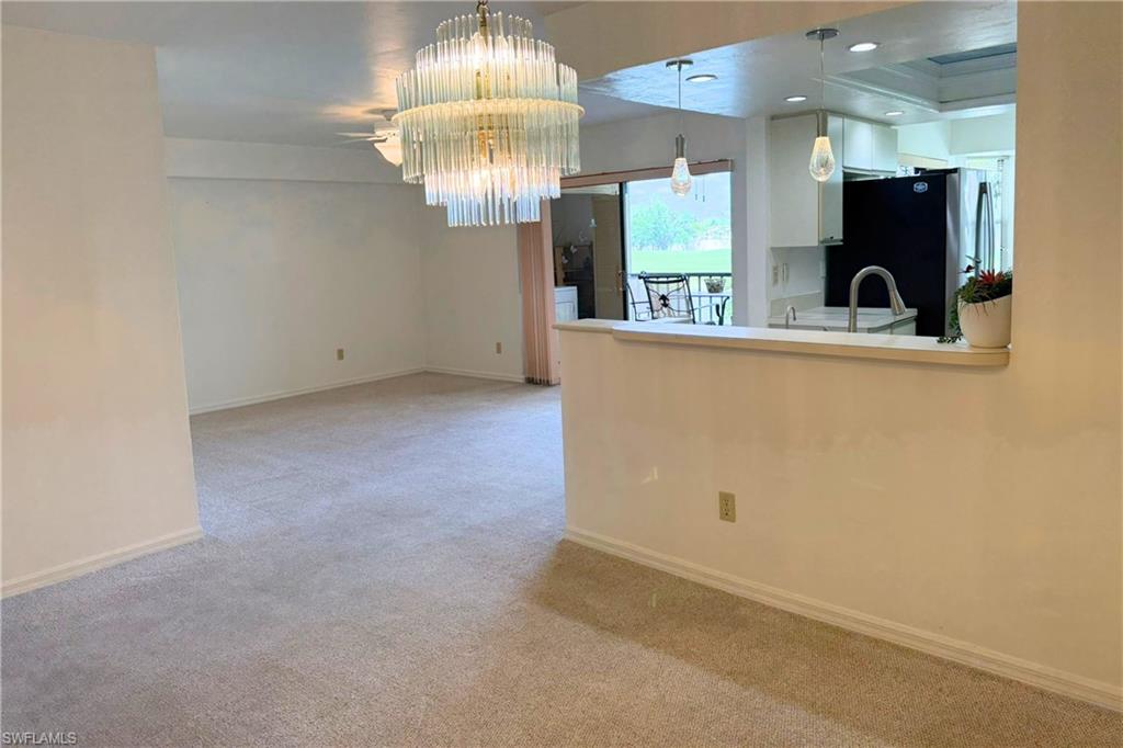 7360 St Ives Way, Unit 2205 Naples, FL 34104 - Photo 5 of 37 a view of a kitchen with a sink and chandelier