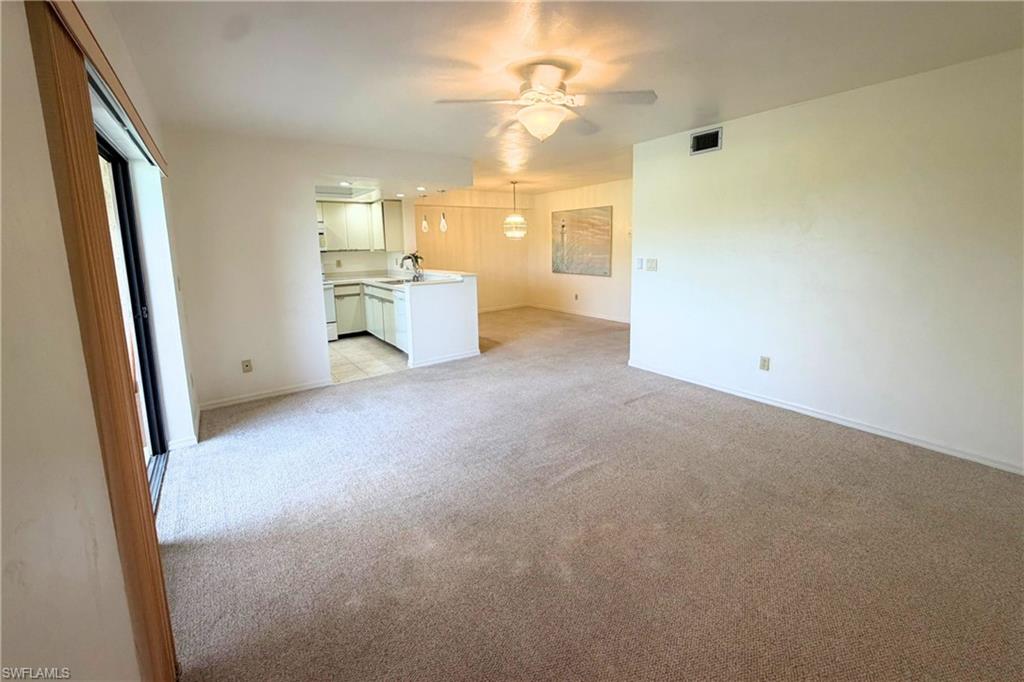 7360 St Ives Way, Unit 2205 Naples, FL 34104 - Photo 7 of 37 wooden floor in an empty room with a window