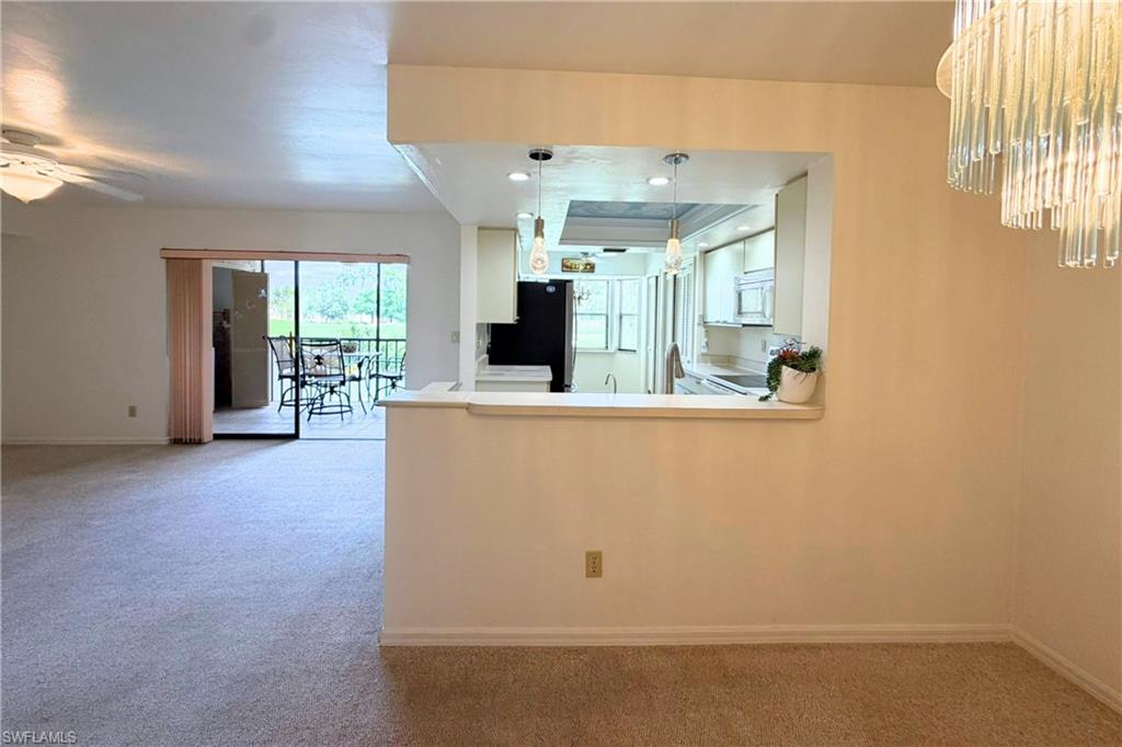 7360 St Ives Way, Unit 2205 Naples, FL 34104 - Photo 9 of 37 a view of kitchen with furniture and large window