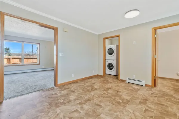 an empty room with closet and windows