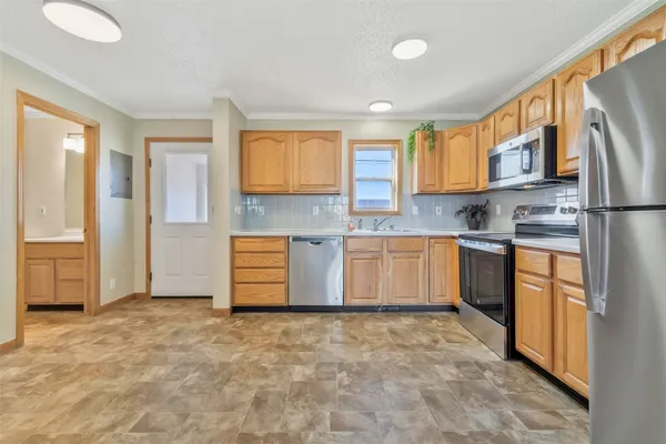 a kitchen with stainless steel appliances granite countertop a refrigerator sink and cabinets