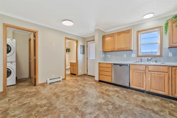 a kitchen with granite countertop a sink cabinets and a window