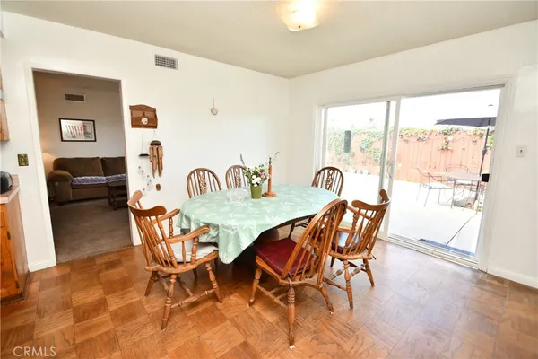a view of a dining room with furniture and a window