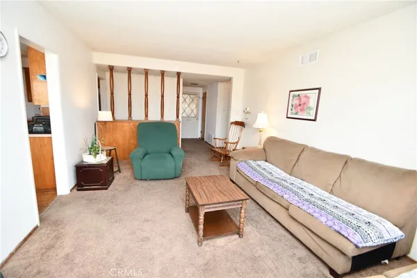 a living room with furniture rug and window