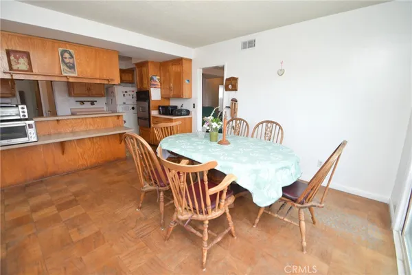 a dining room with furniture and wooden floor