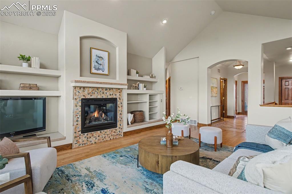 4215 Star Ranch Road Colorado Springs, CO 80906 - Photo 20 of 44 a living room with furniture a flat screen tv and a fireplace