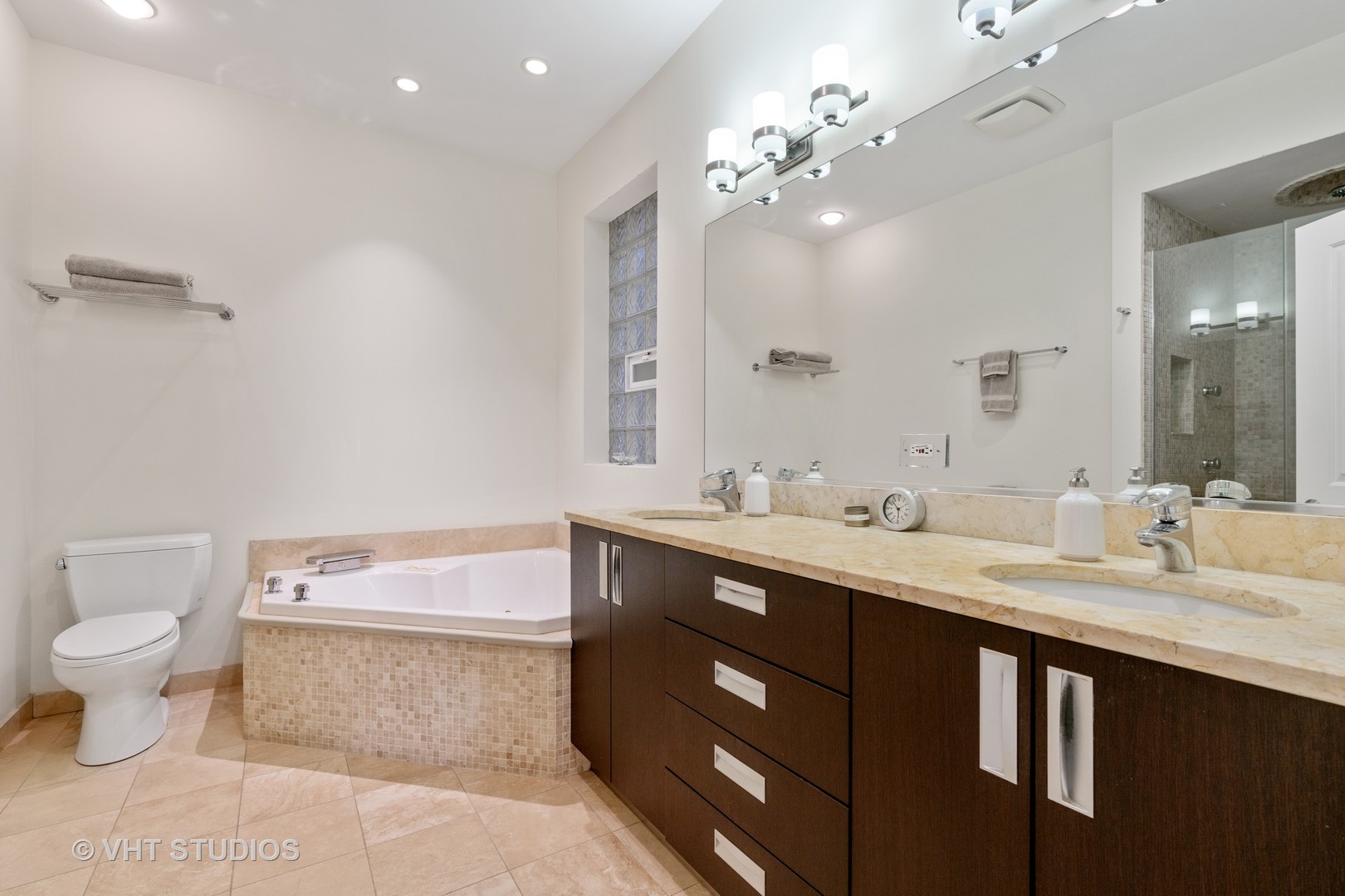 Undisclosed Address Chicago, IL 60622 - Photo 13 of 25 a spacious bathroom with a double vanity sink mirror and toilet